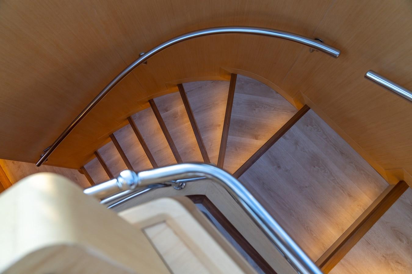 a wooden bunk bed with a light fixture aboard JASMINA III Yacht for Sale