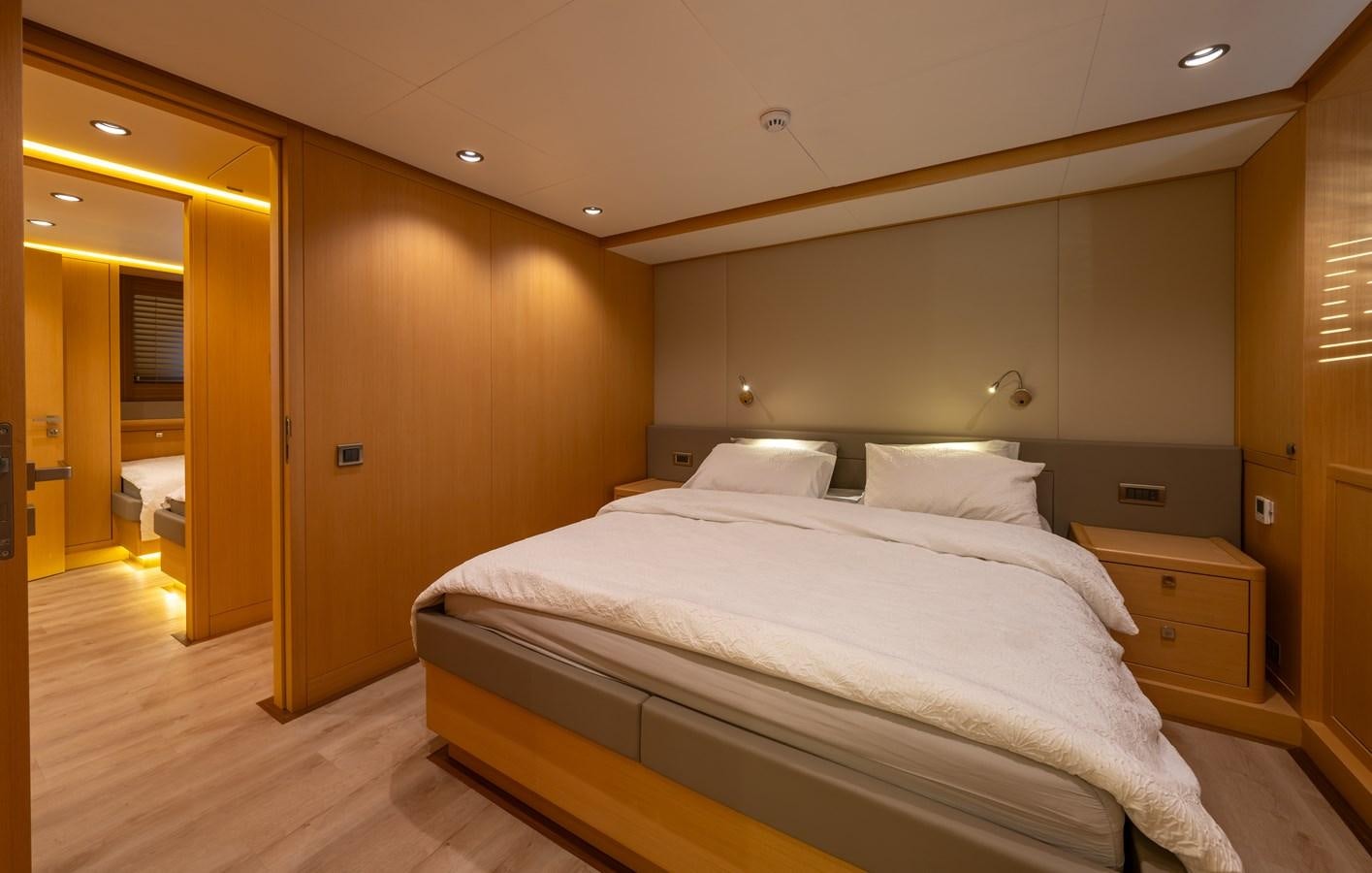 a room with a bed and a closet aboard JASMINA III Yacht for Sale