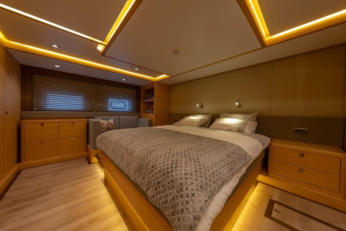 a room with a bed and a desk aboard JASMINA III Yacht for Sale