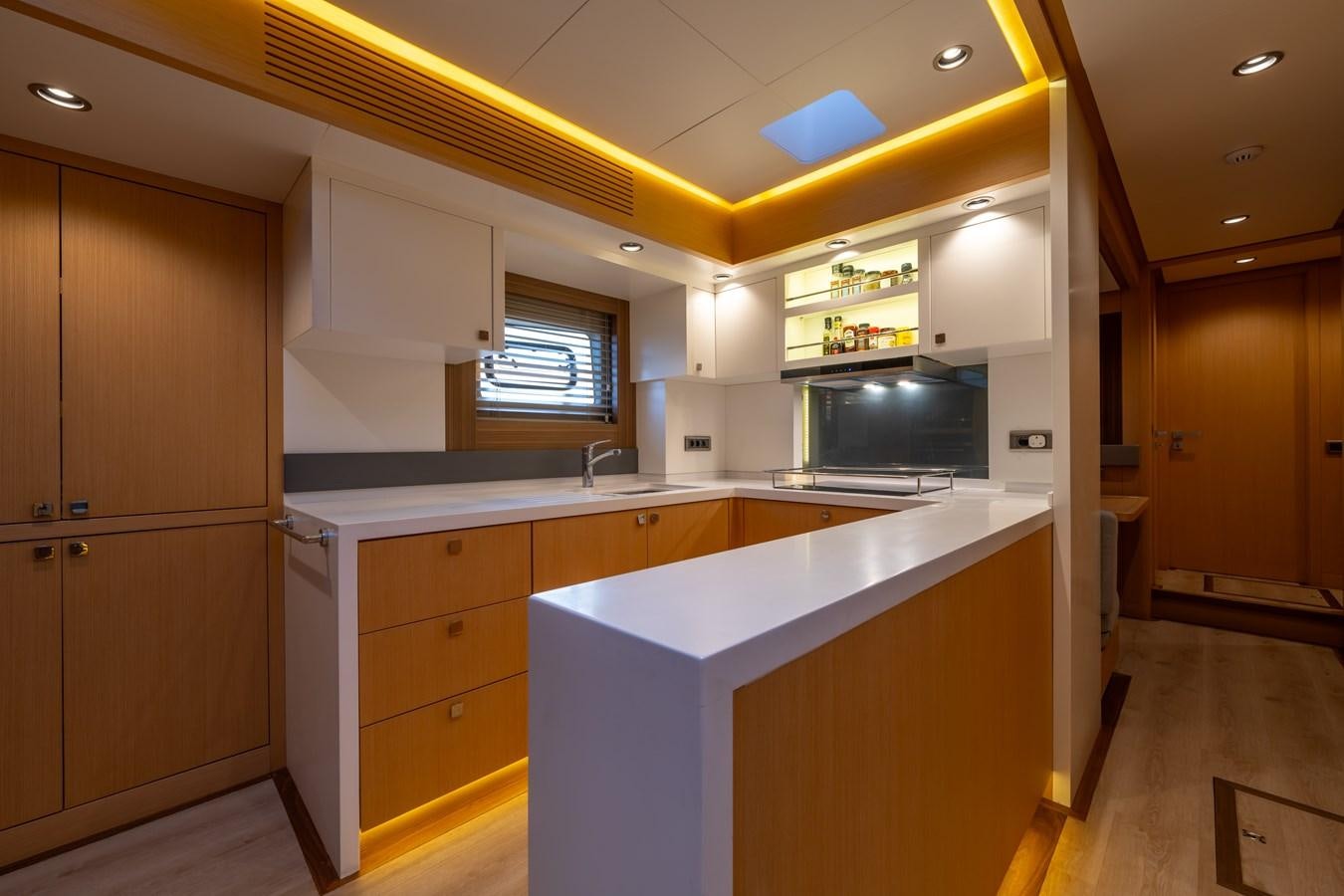 a kitchen with a large island aboard JASMINA III Yacht for Sale