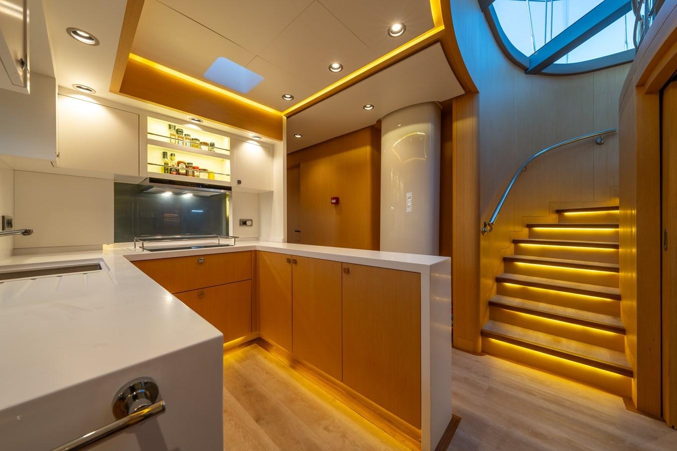 a kitchen with a staircase and a microwave aboard JASMINA III Yacht for Sale
