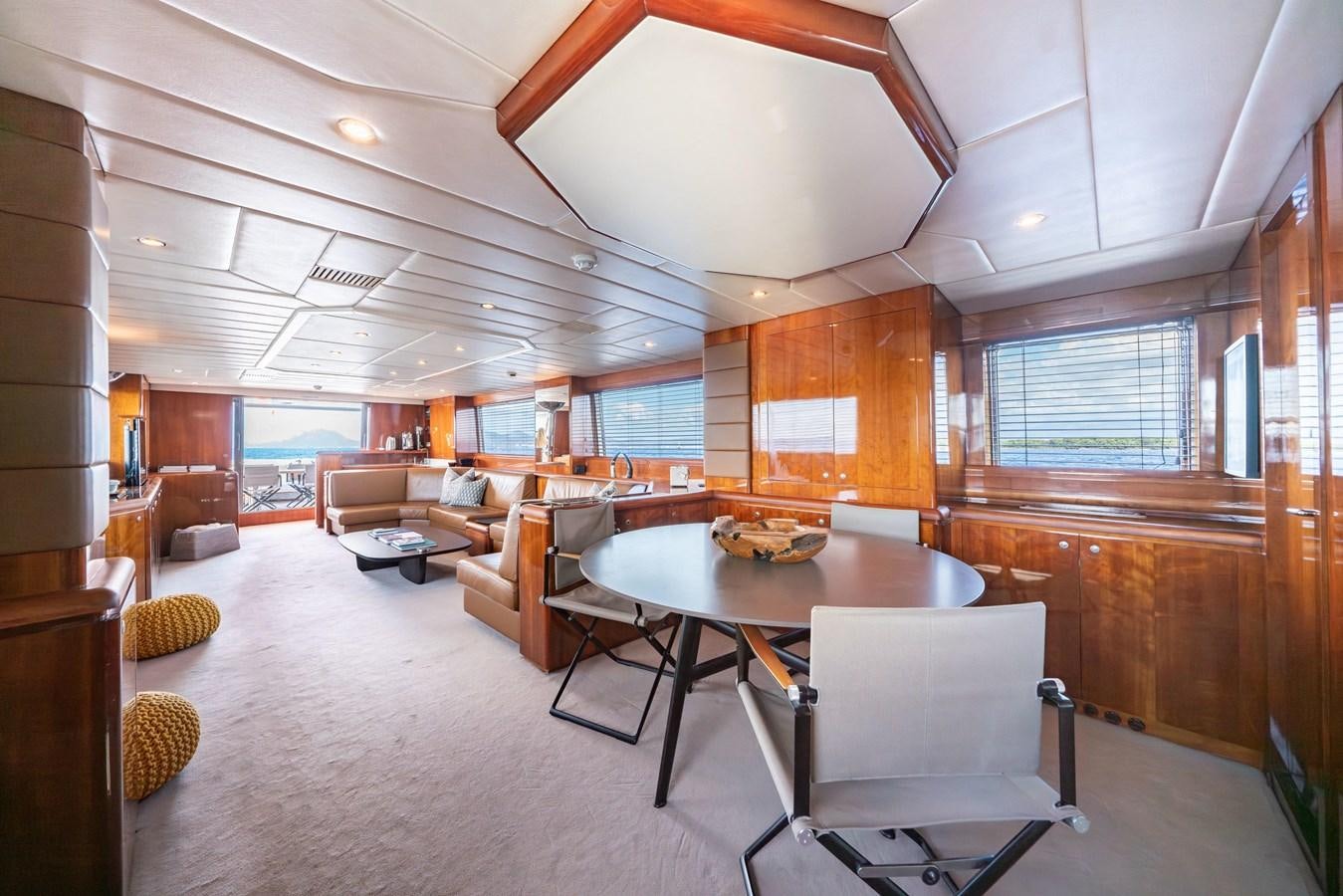 a large room with a table and chairs aboard MOONRAKER II Yacht for Sale