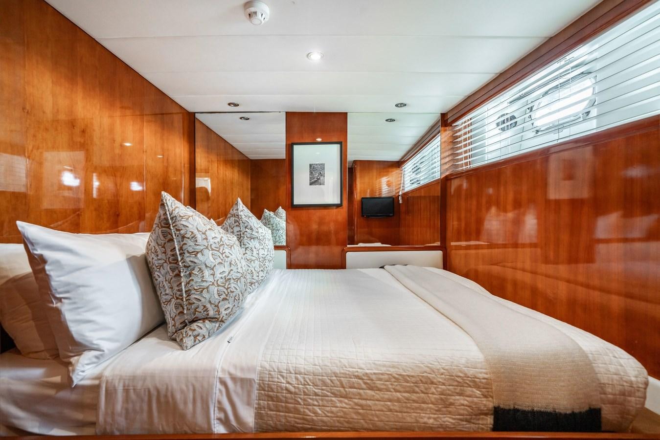 a bed with white sheets aboard MOONRAKER II Yacht for Sale