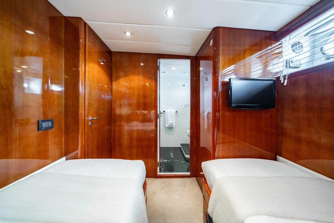 a room with a bed and a television aboard MOONRAKER II Yacht for Sale