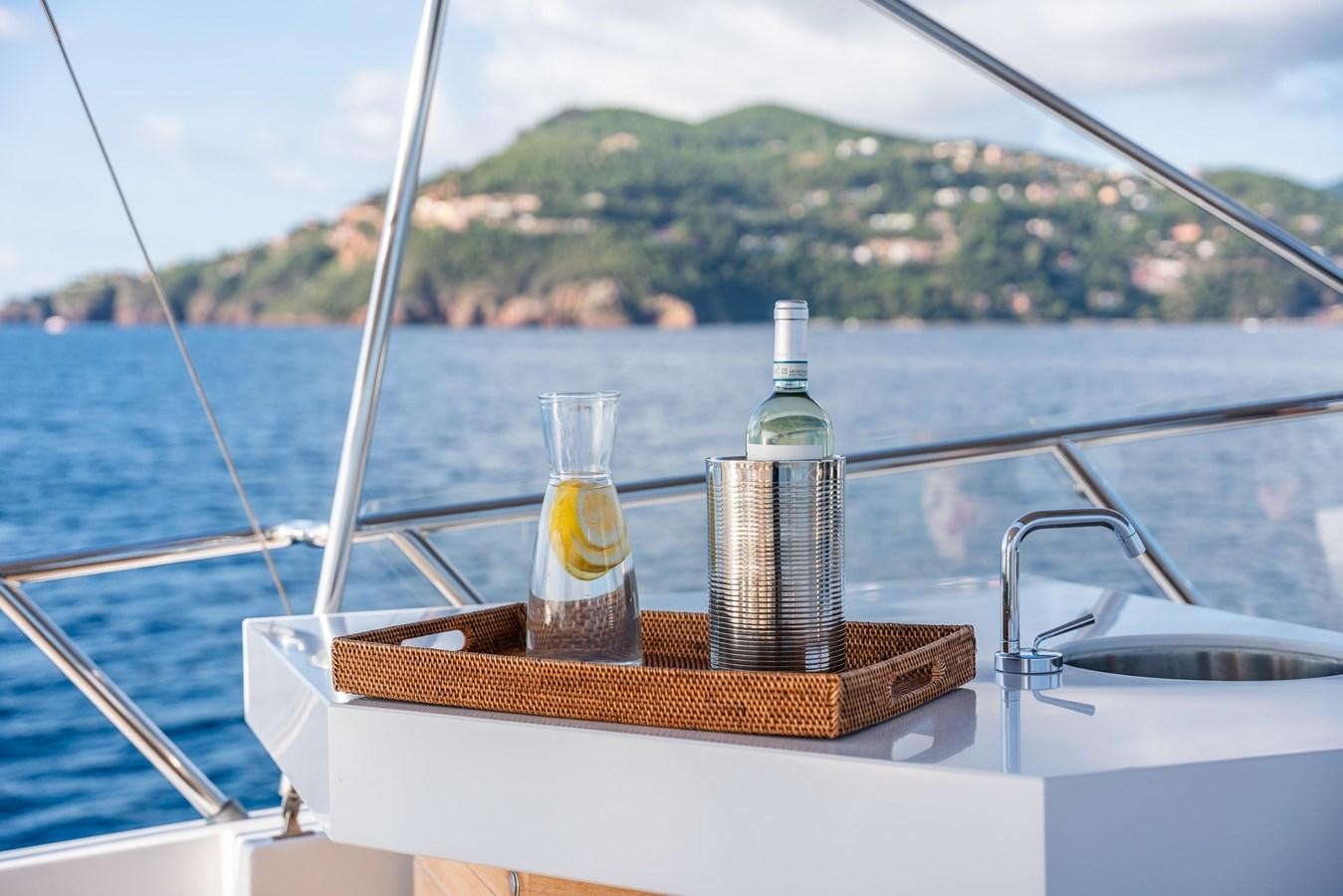 a bottle of liquor on a boat aboard MOONRAKER II Yacht for Sale