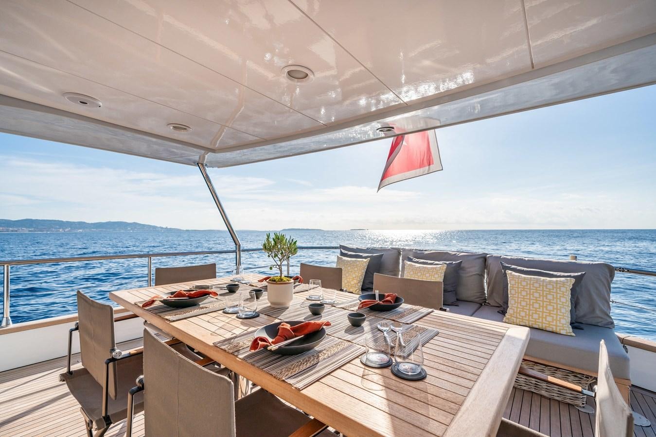 a table with chairs on it aboard MOONRAKER II Yacht for Sale