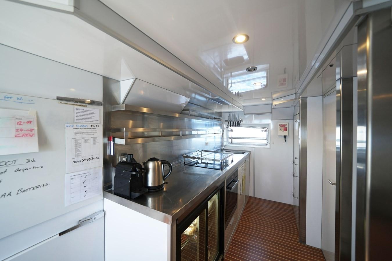 a kitchen with a large window aboard MOONRAKER II Yacht for Sale