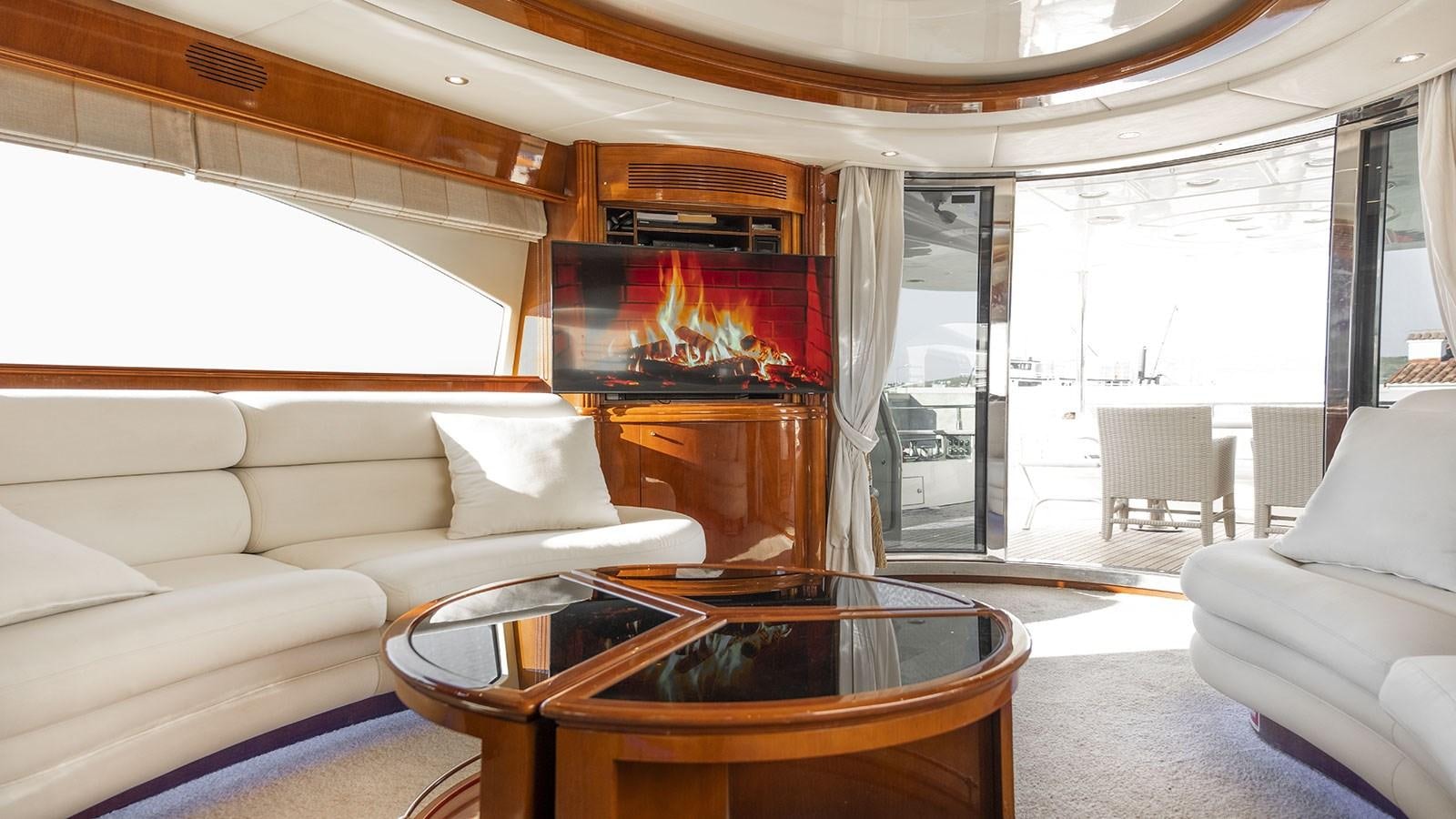 a living room with a fireplace aboard TITAN Yacht for Sale