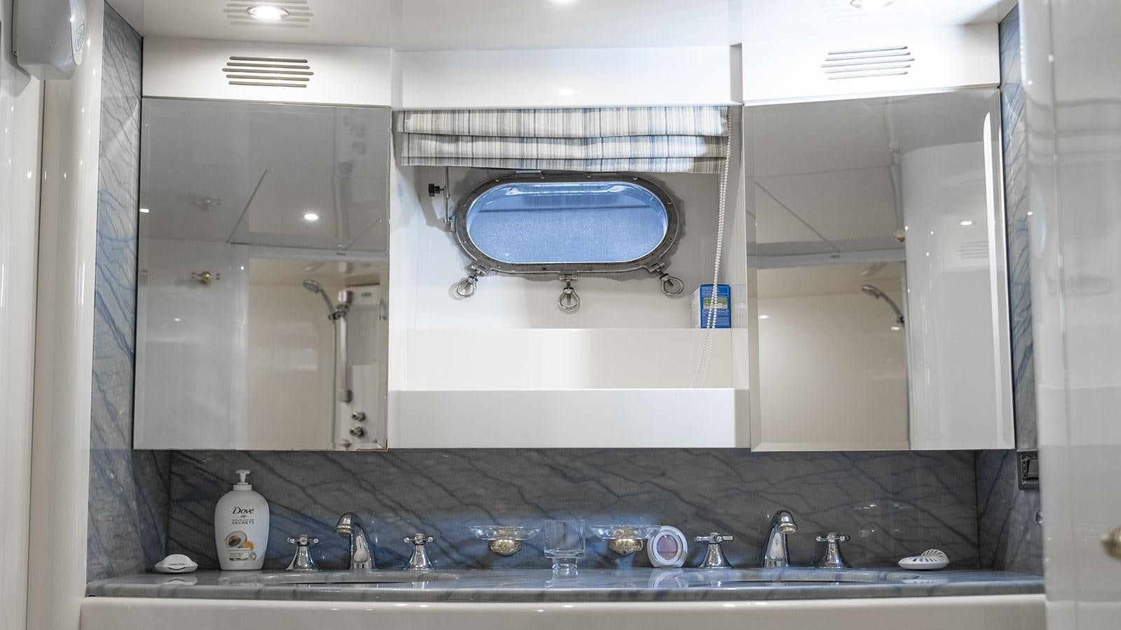 a bathroom with a large mirror aboard TITAN Yacht for Sale