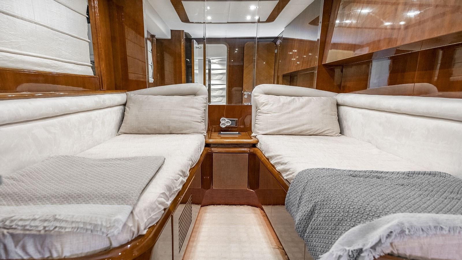 a cabin with a bed and a table aboard TITAN Yacht for Sale