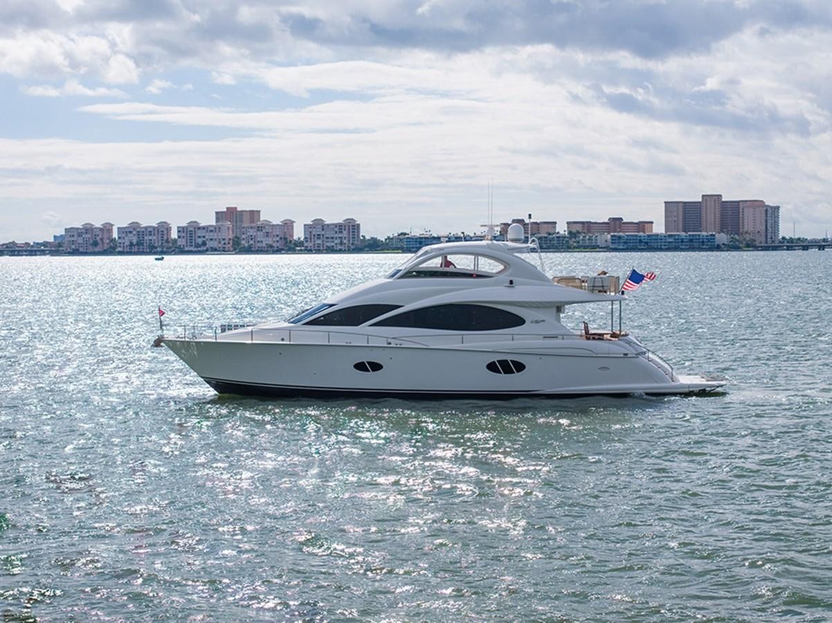 a white yacht in the water aboard BODACIOUS VI Yacht for Sale