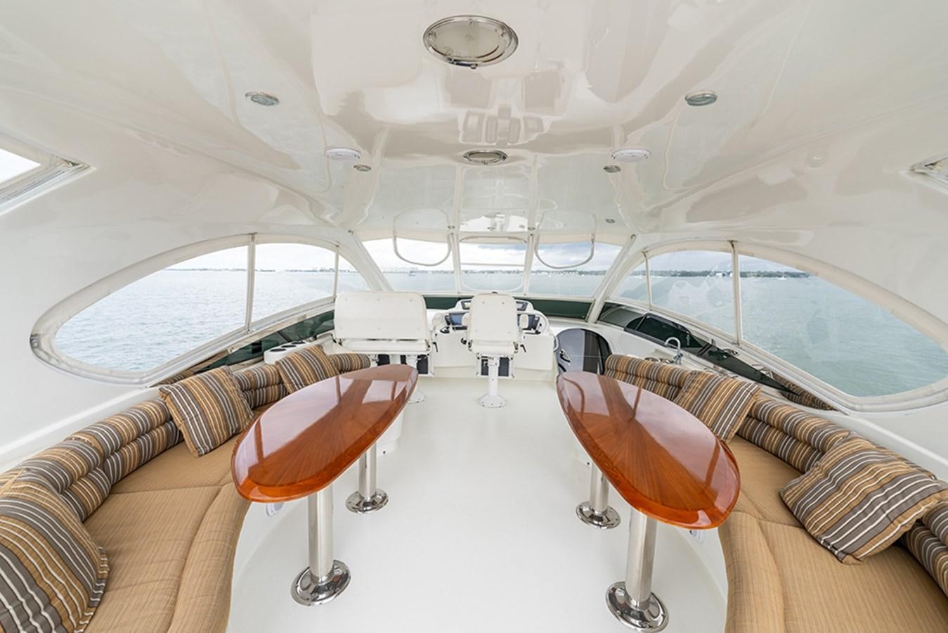 a room with a chair and a table and a couch aboard BODACIOUS VI Yacht for Sale