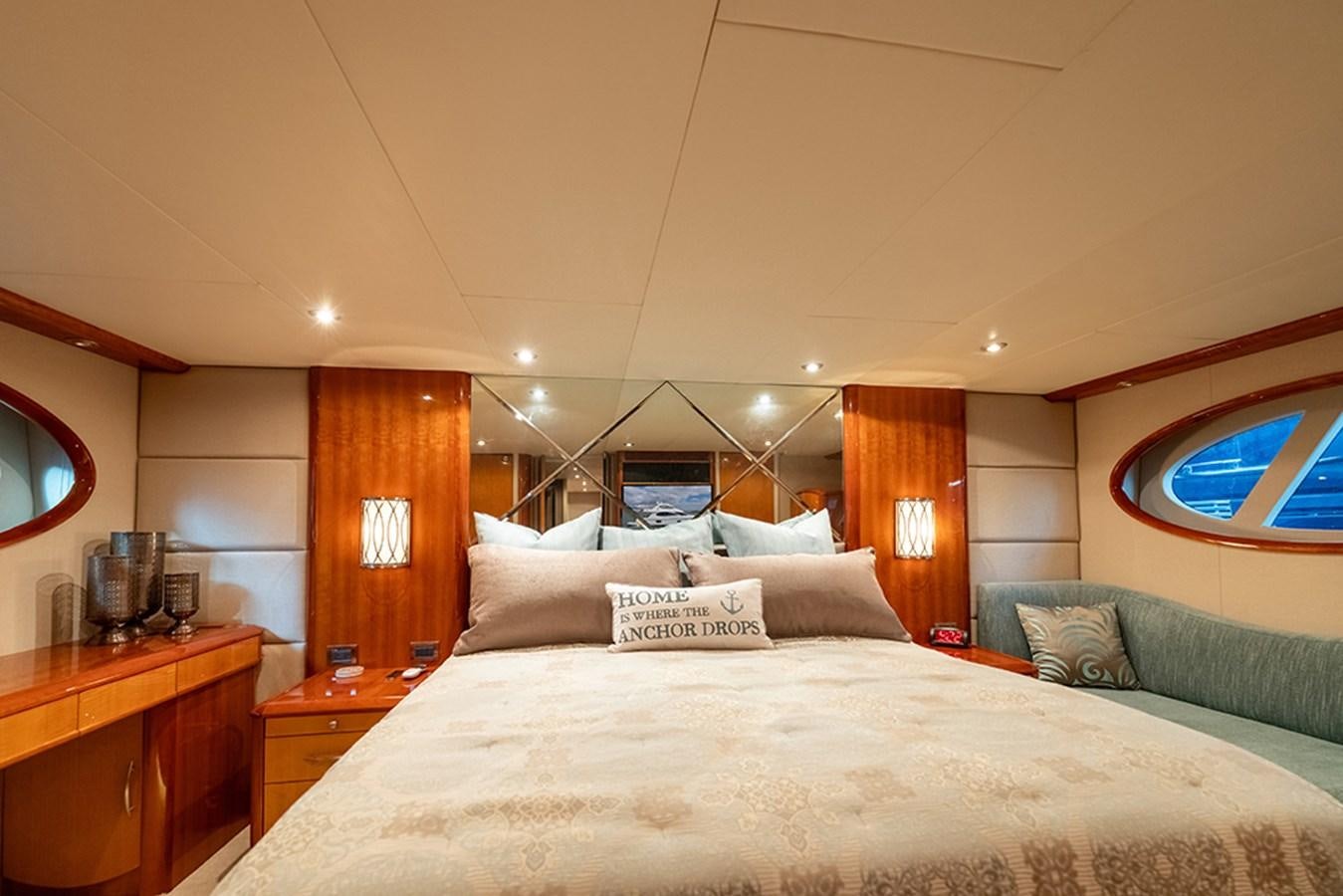 a bed with a white bed spread aboard BODACIOUS VI Yacht for Sale