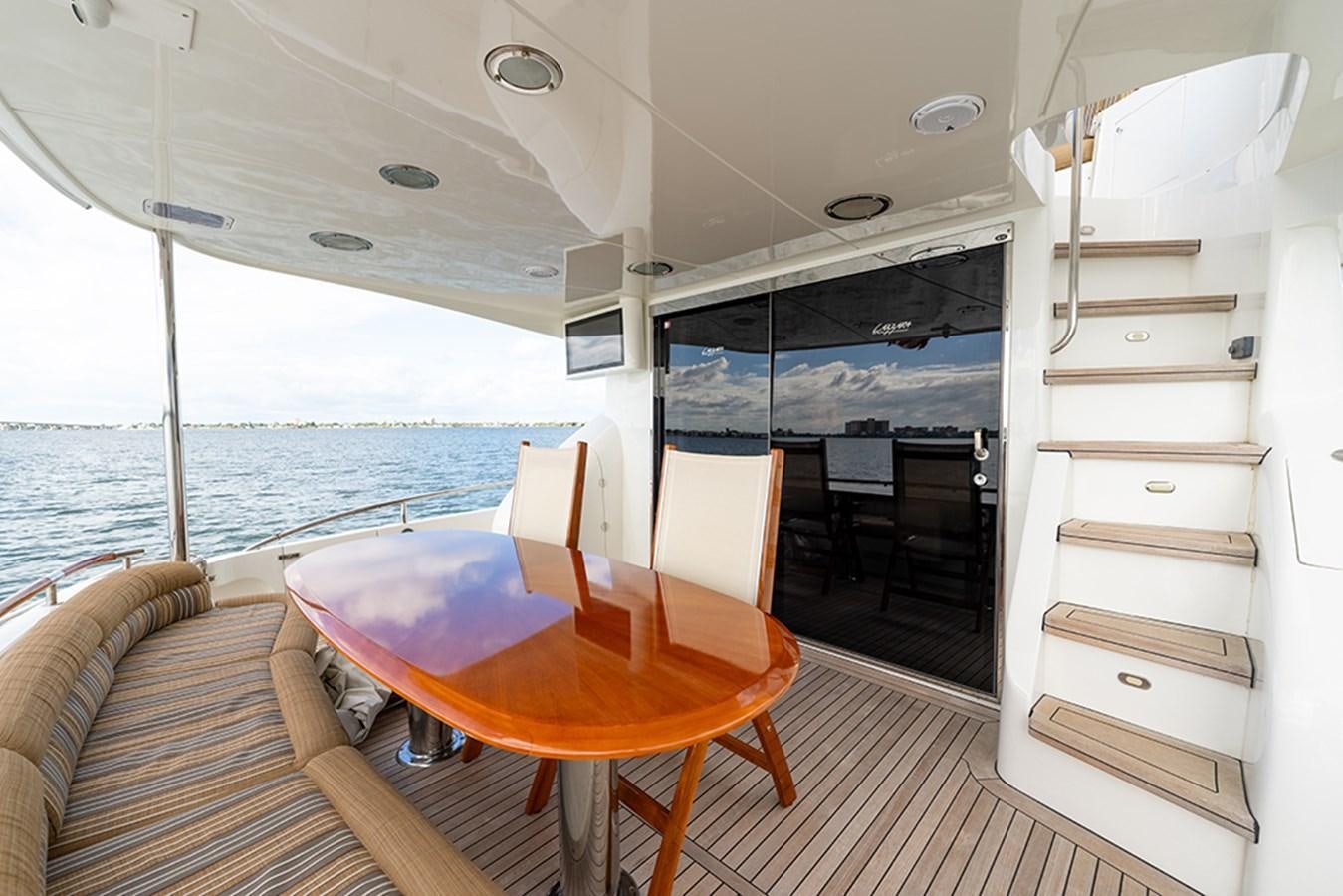 a room with a table and chairs aboard BODACIOUS VI Yacht for Sale