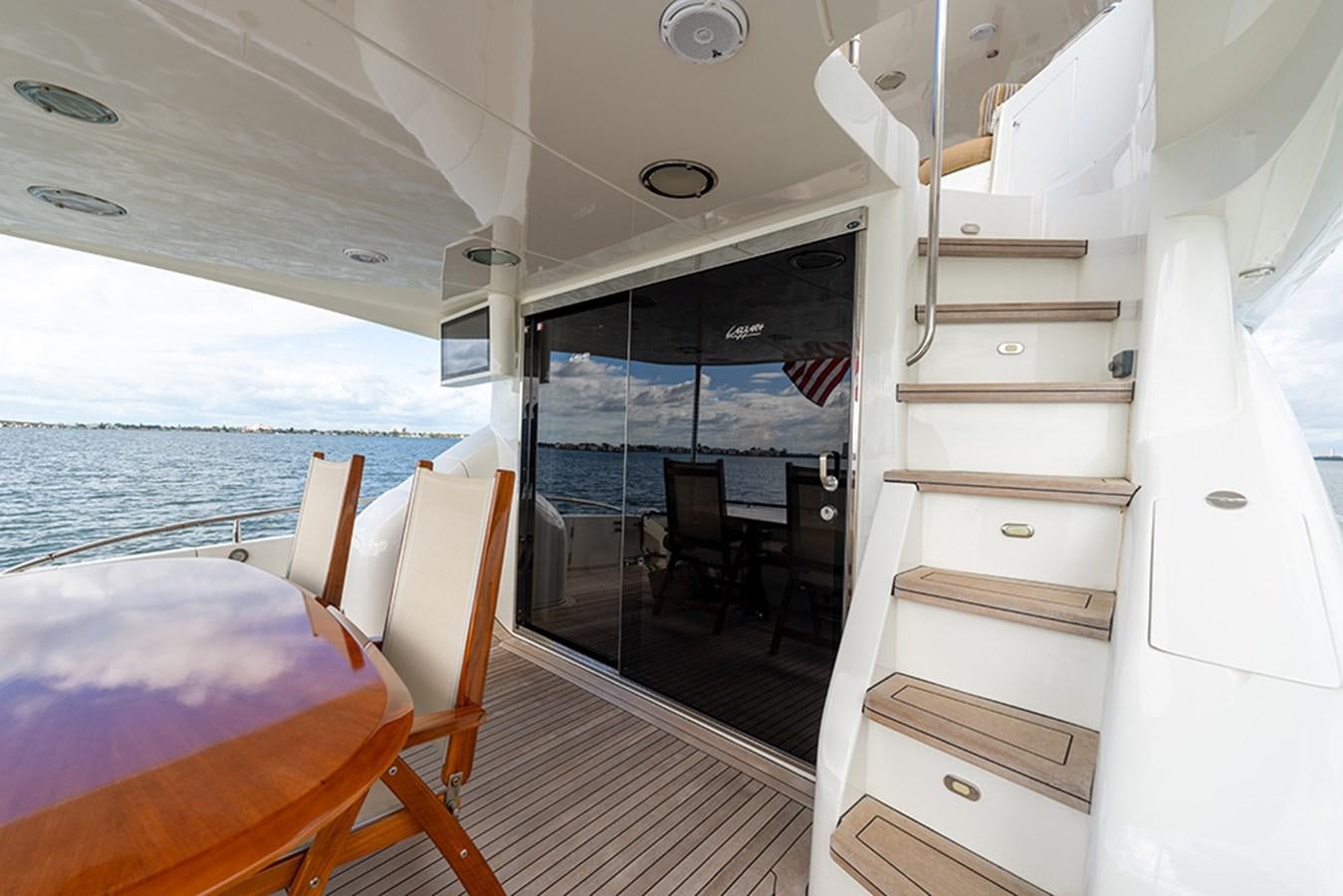 a boat with a bed and a table and chairs aboard BODACIOUS VI Yacht for Sale