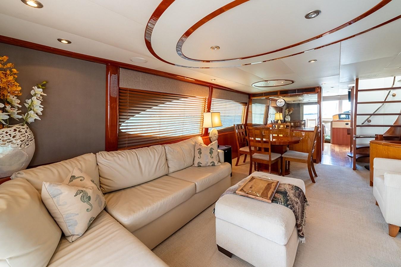 a living room with a couch and a table aboard BODACIOUS VI Yacht for Sale