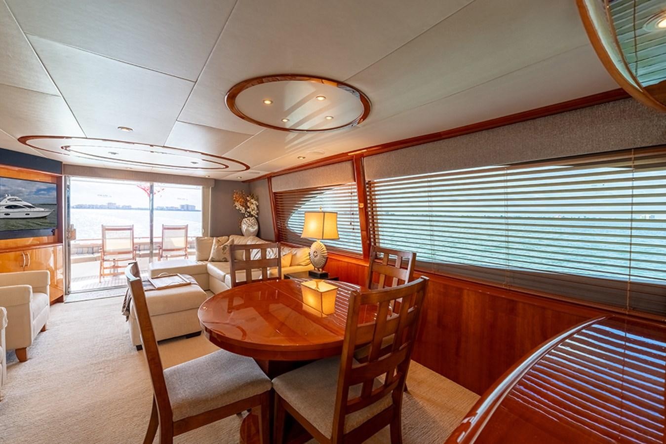a dining room with a table and chairs aboard BODACIOUS VI Yacht for Sale