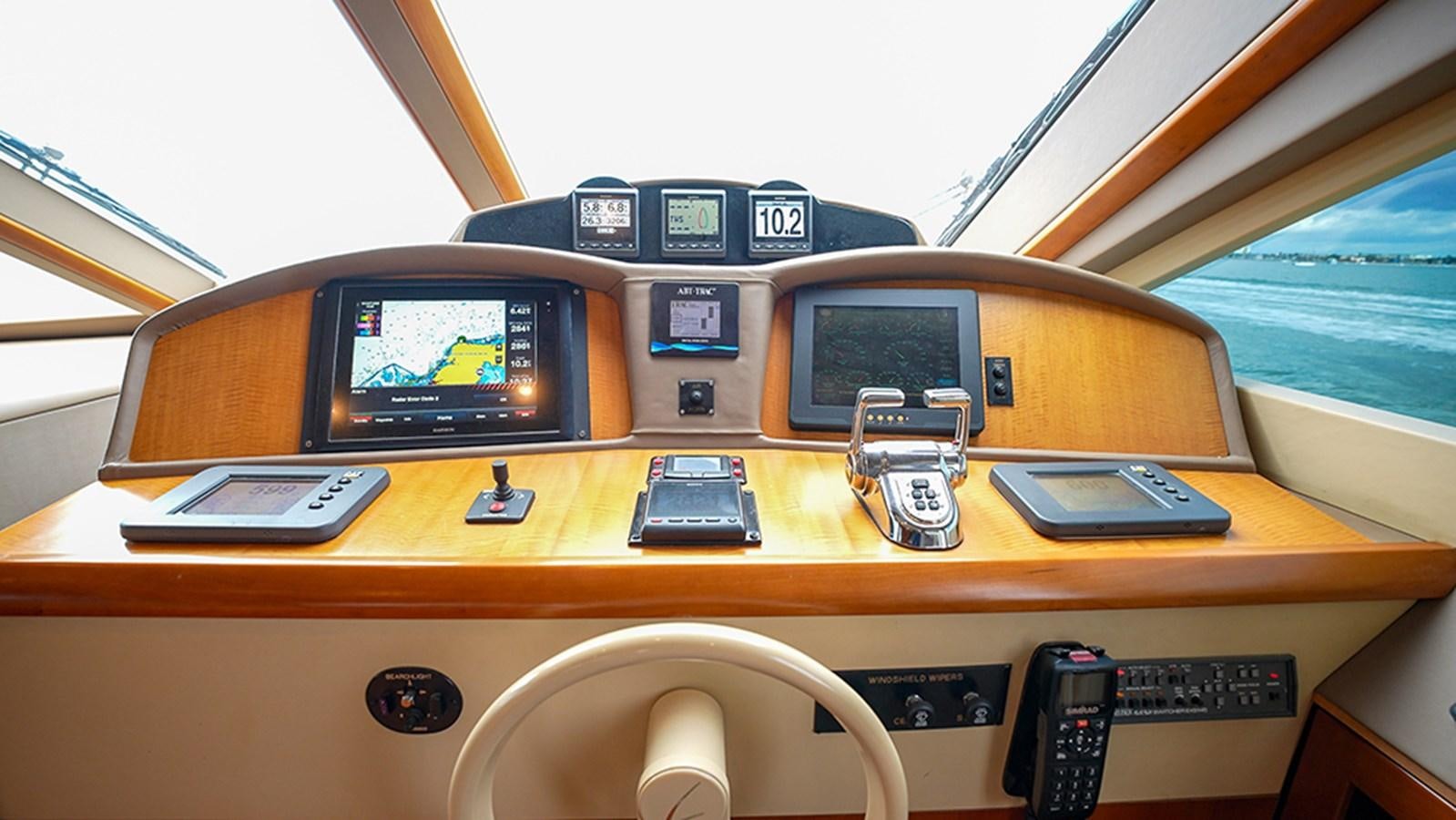 a yellow vehicle with a screen and a cell phone on top aboard BODACIOUS VI Yacht for Sale