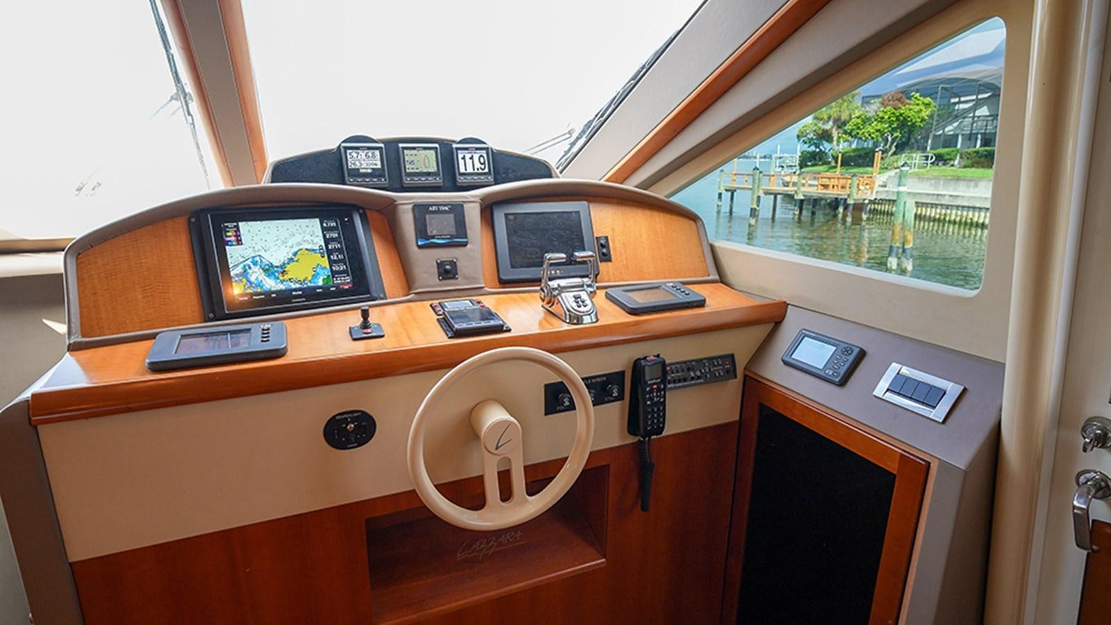 a desk with a phone and a radio on it aboard BODACIOUS VI Yacht for Sale