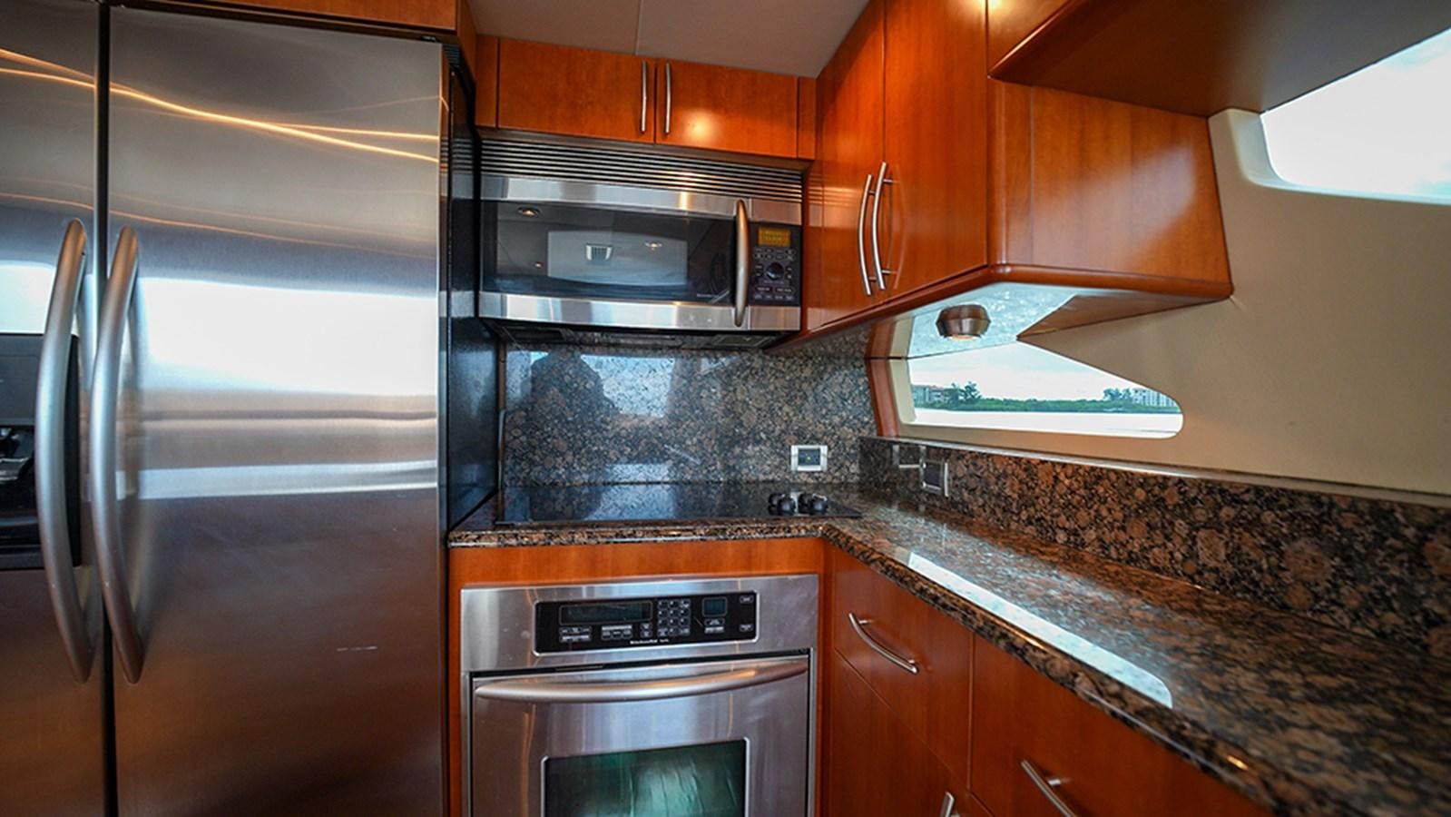 a kitchen with stainless steel appliances aboard BODACIOUS VI Yacht for Sale