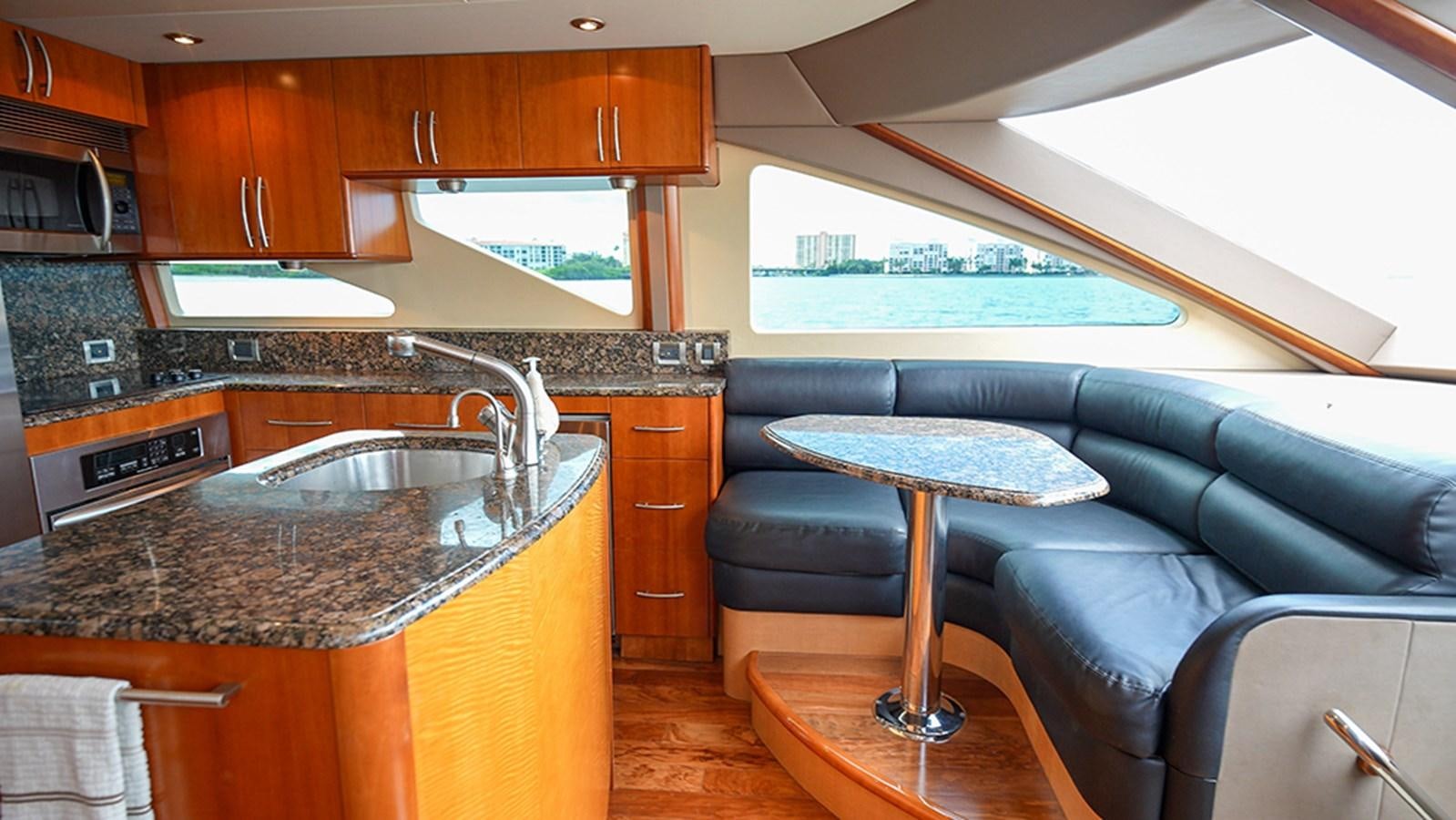 a kitchen with a leather couch aboard BODACIOUS VI Yacht for Sale