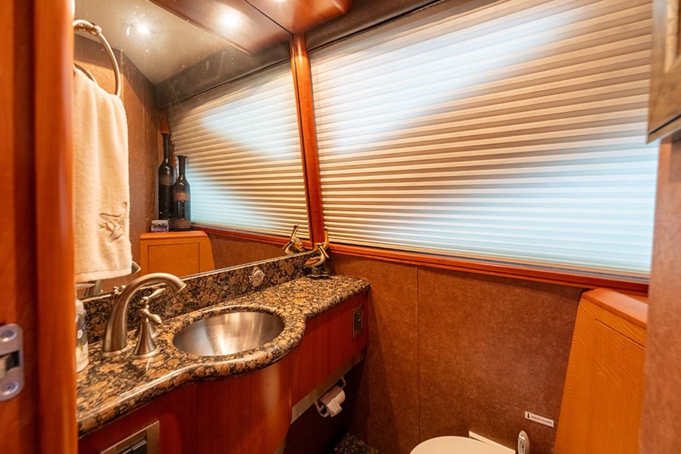 a bathroom with a sink and a window aboard BODACIOUS VI Yacht for Sale