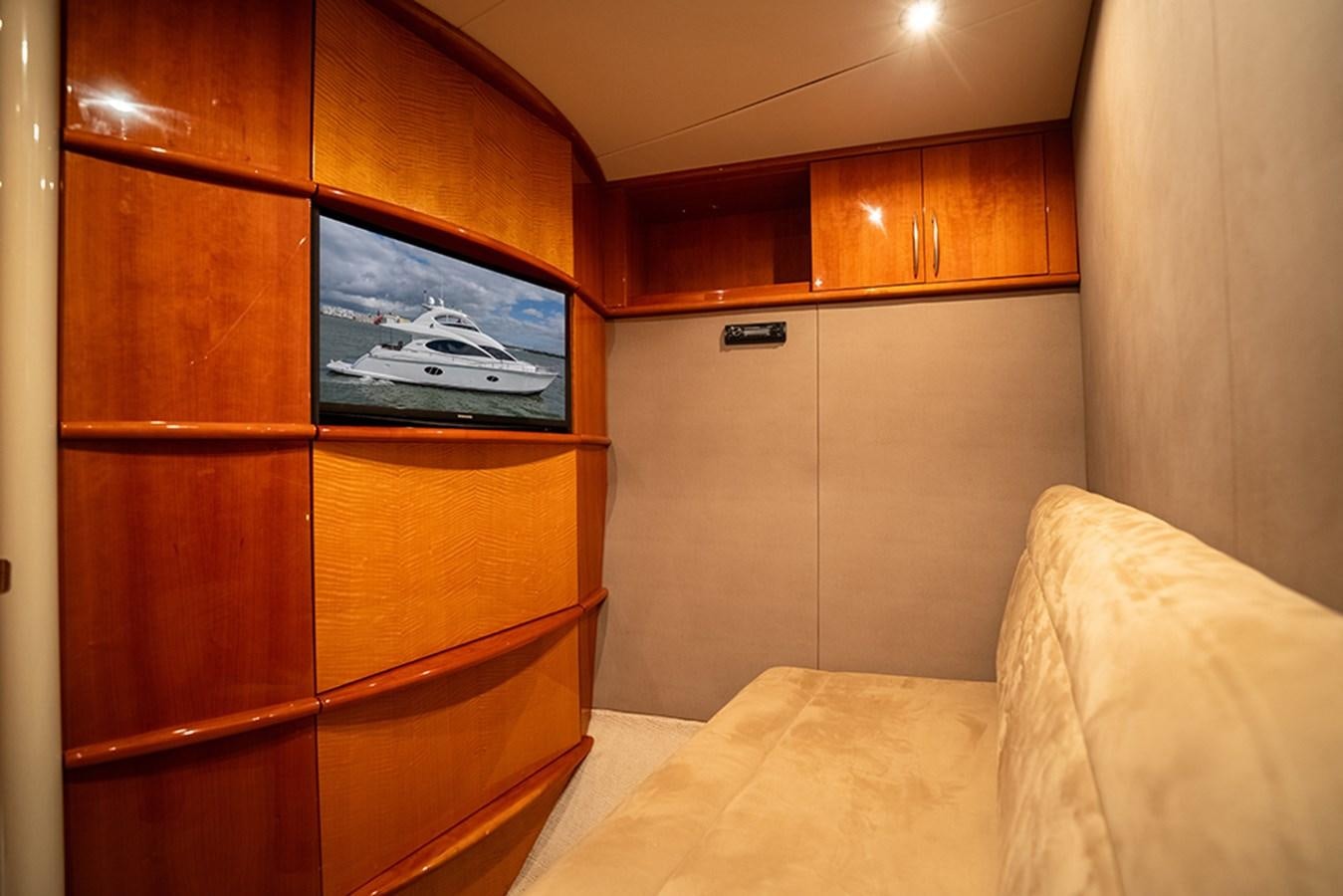 a room with a tv and a bed aboard BODACIOUS VI Yacht for Sale