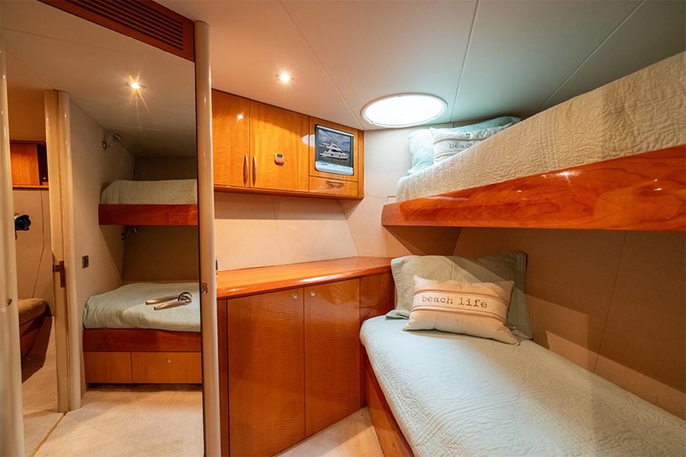 a room with bunk beds aboard BODACIOUS VI Yacht for Sale