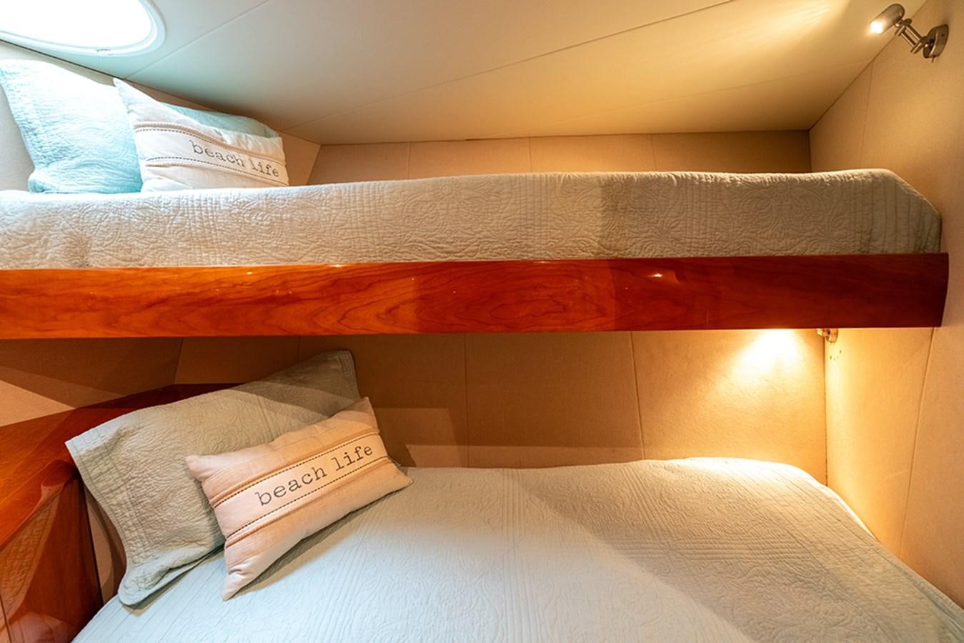 a bed with pillows aboard BODACIOUS VI Yacht for Sale