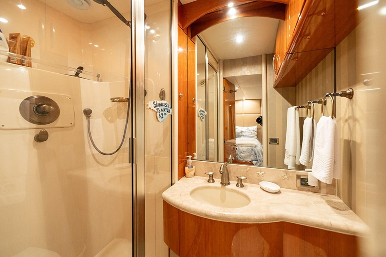 a bathroom with a large mirror aboard BODACIOUS VI Yacht for Sale