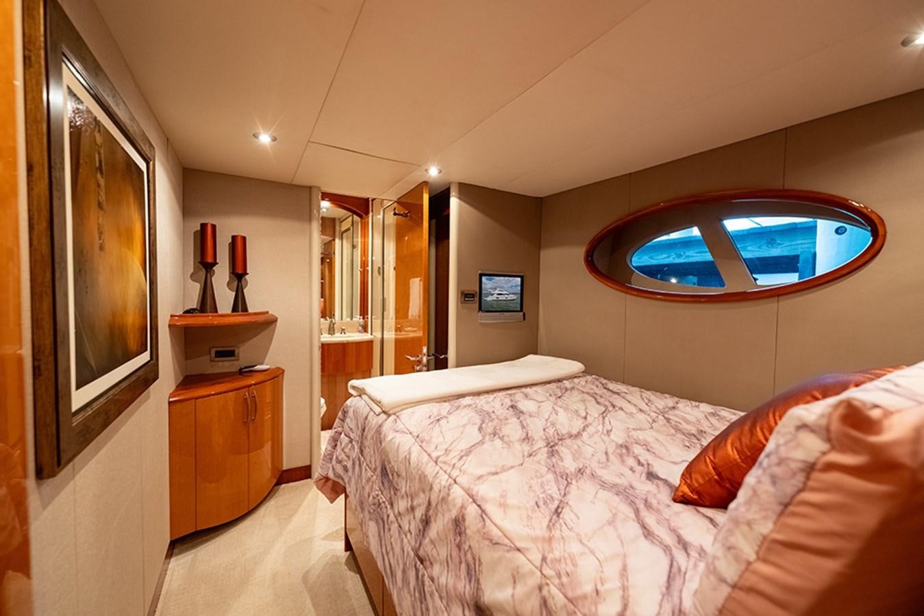 a bedroom with a large mirror aboard BODACIOUS VI Yacht for Sale