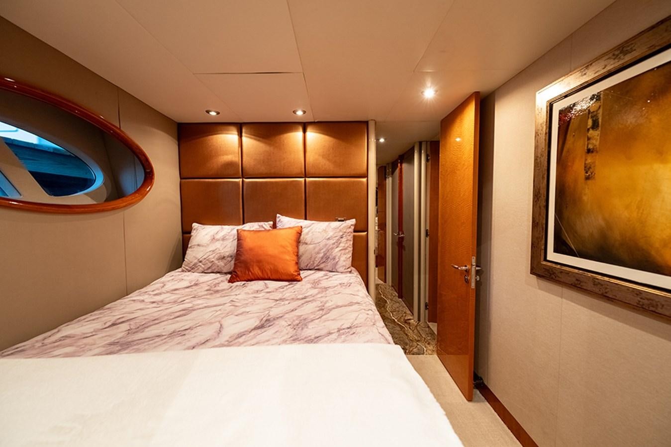 a bed with a white sheet and pillows aboard BODACIOUS VI Yacht for Sale