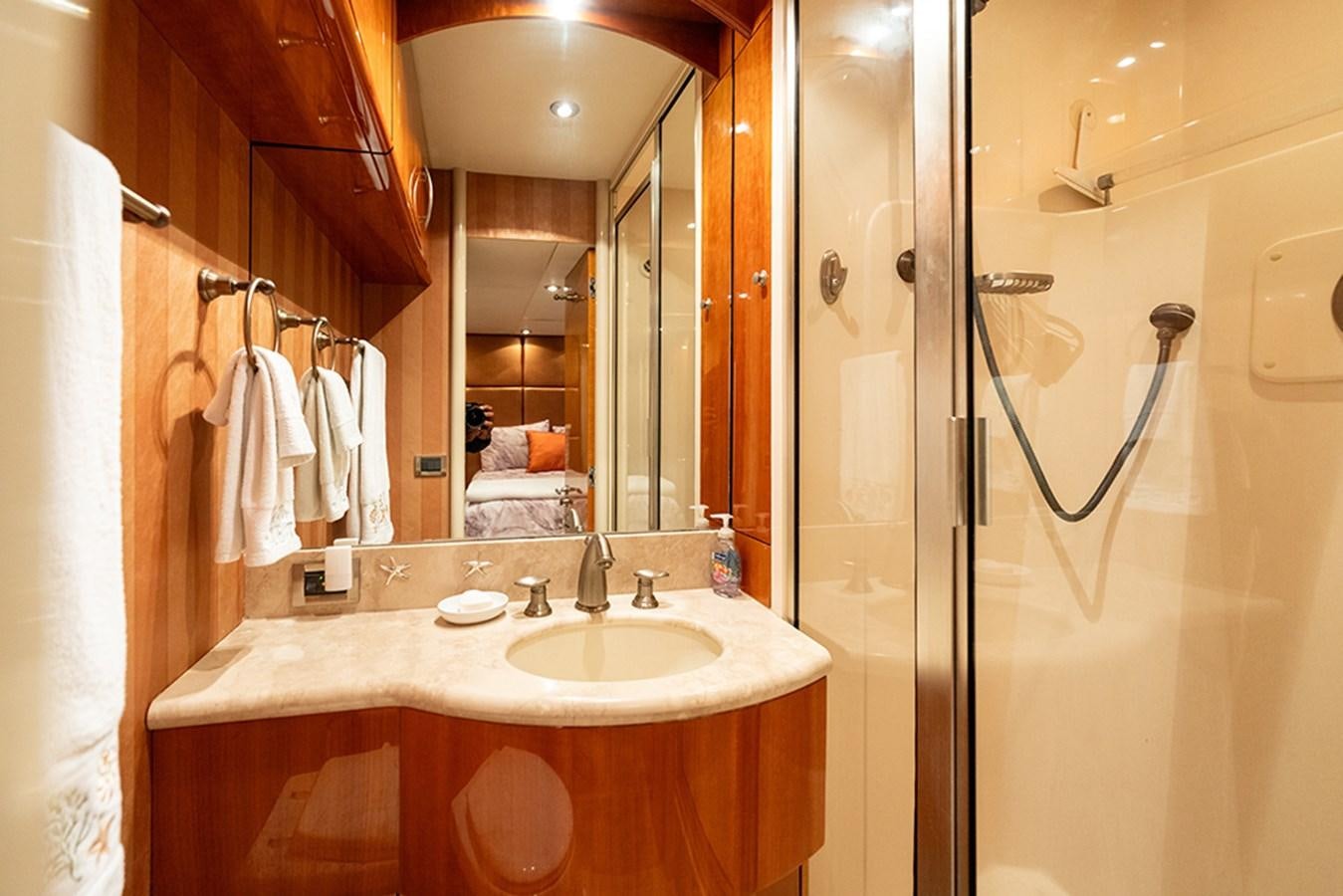 a bathroom with a sink and a mirror aboard BODACIOUS VI Yacht for Sale