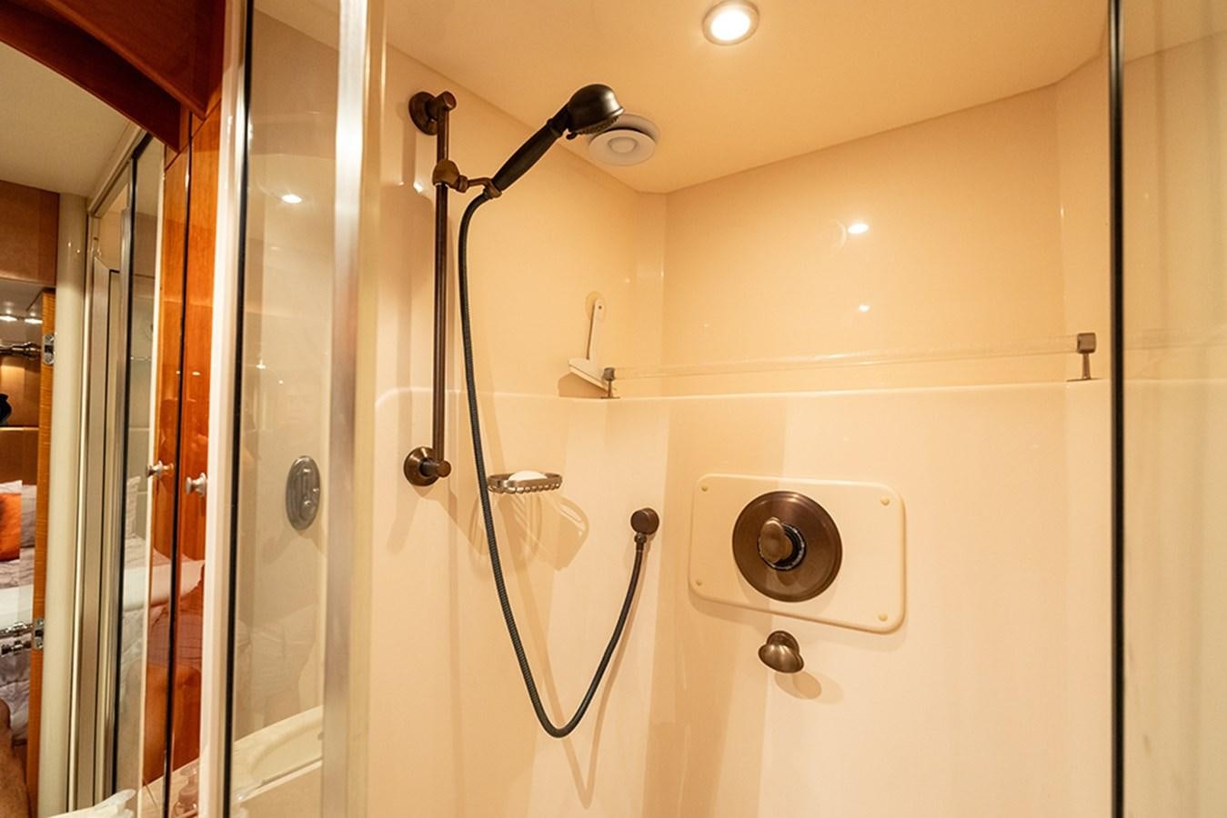 a bathroom with a shower and a sink aboard BODACIOUS VI Yacht for Sale