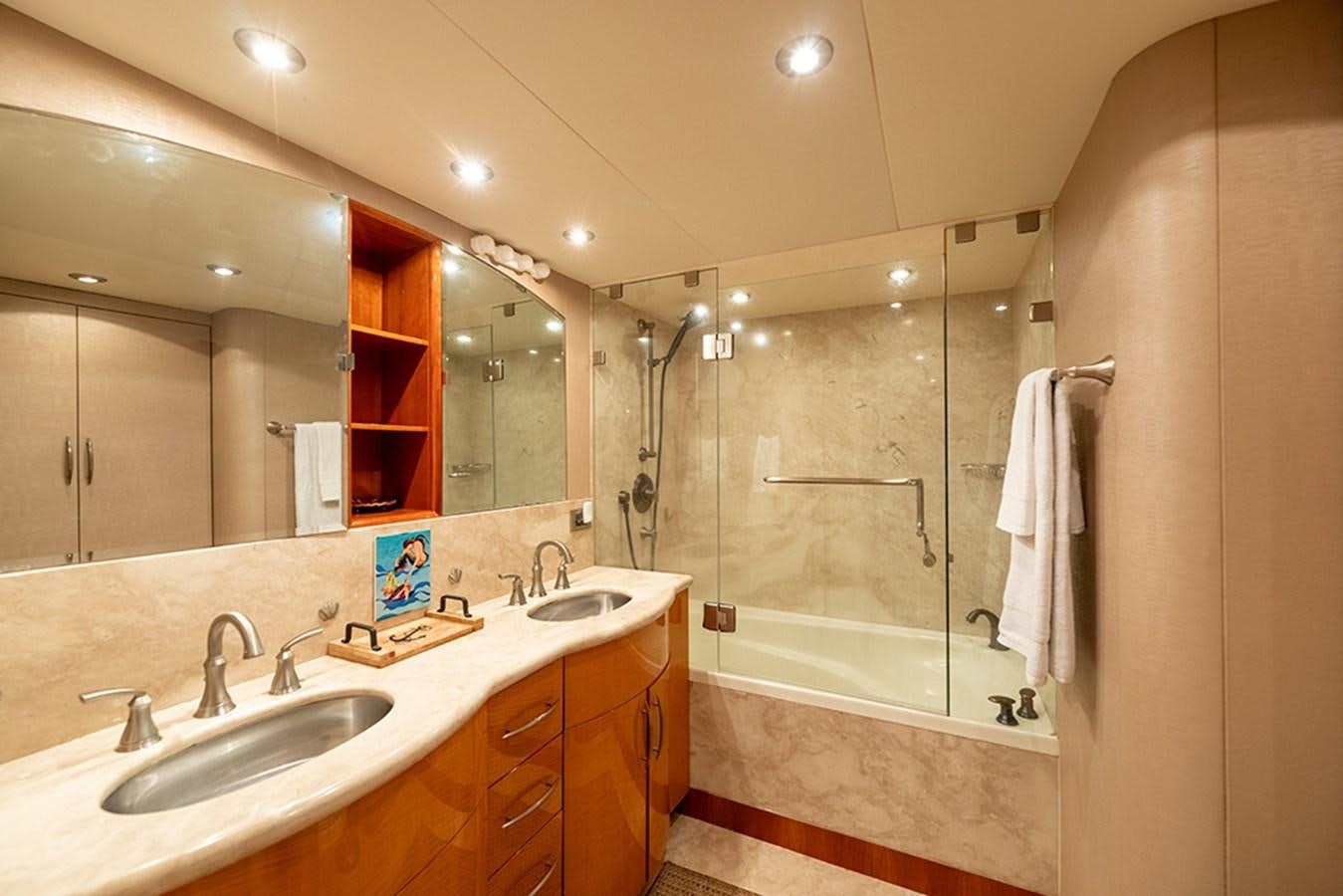a bathroom with a large mirror aboard BODACIOUS VI Yacht for Sale