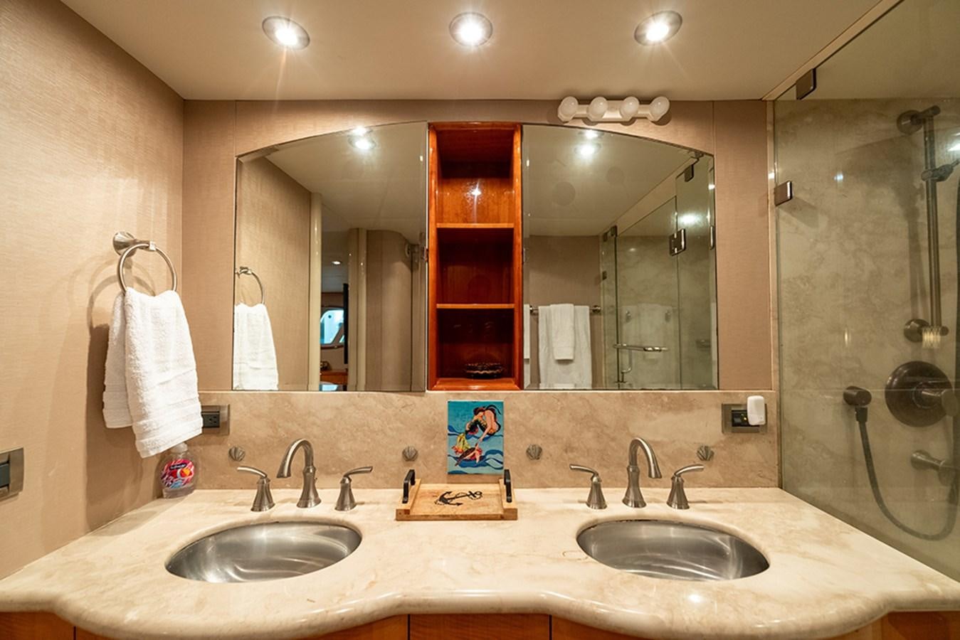 a bathroom with a large mirror aboard BODACIOUS VI Yacht for Sale