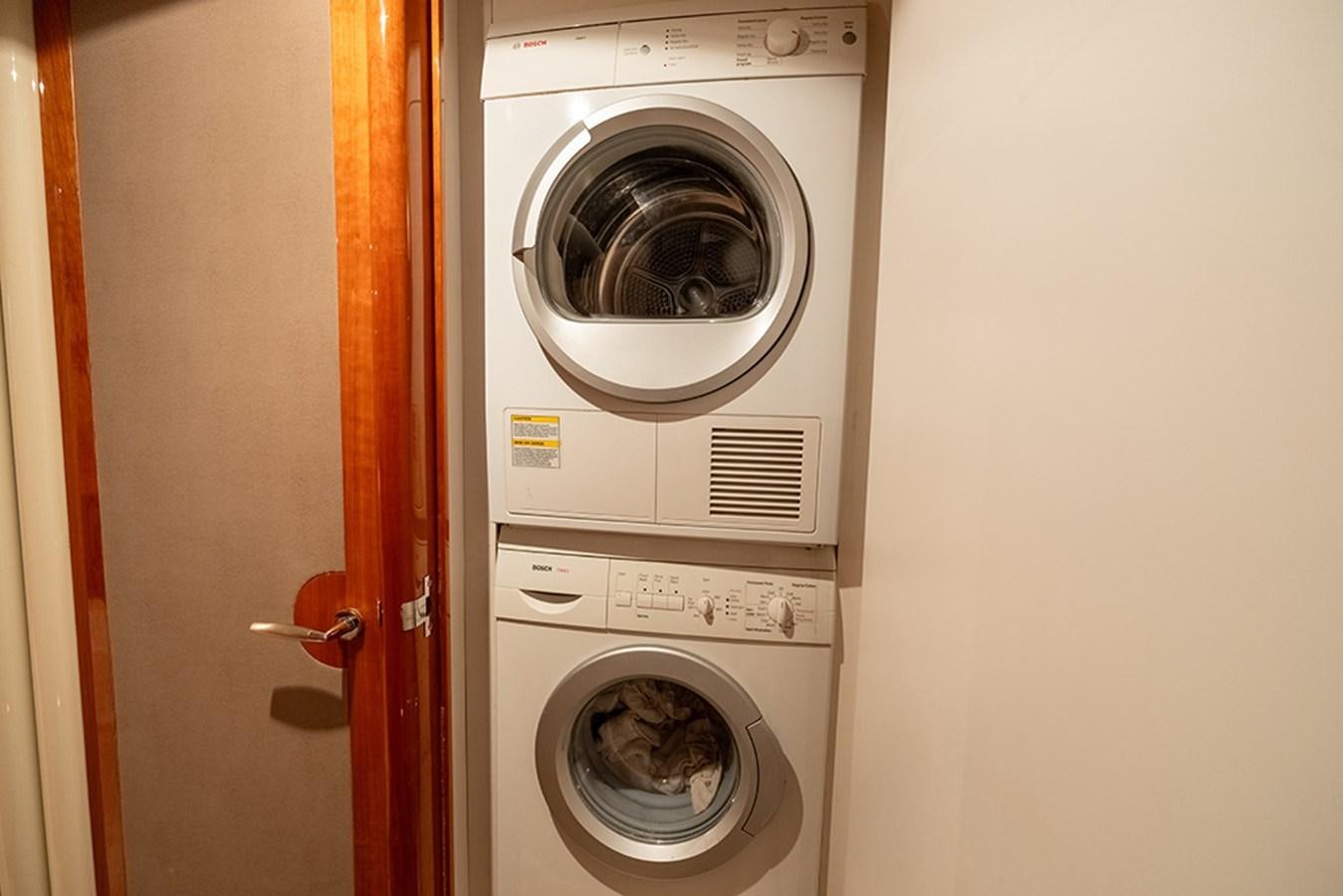 a closet with washer and dryer aboard BODACIOUS VI Yacht for Sale