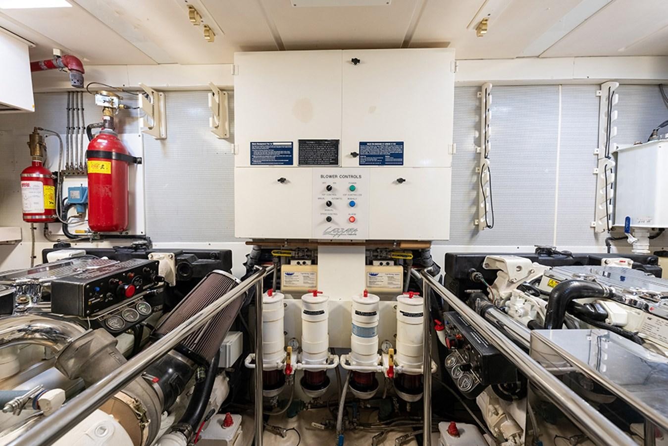 a room with machinery and pipes aboard BODACIOUS VI Yacht for Sale