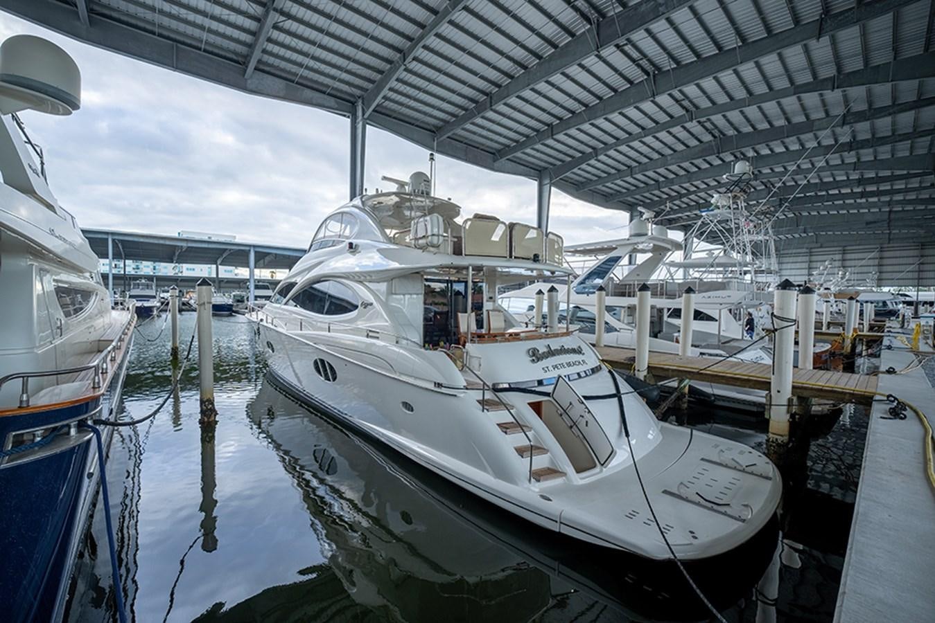 a couple of boats are parked in a harbor aboard BODACIOUS VI Yacht for Sale