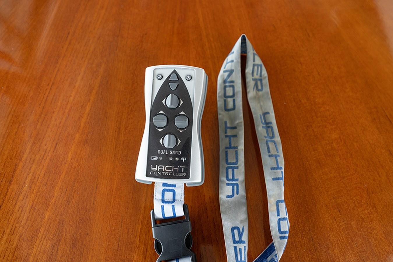 a remote control next to a ruler aboard BODACIOUS VI Yacht for Sale
