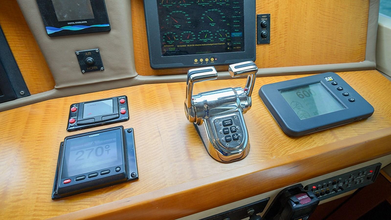 a table with cell phones and a camera on it aboard BODACIOUS VI Yacht for Sale