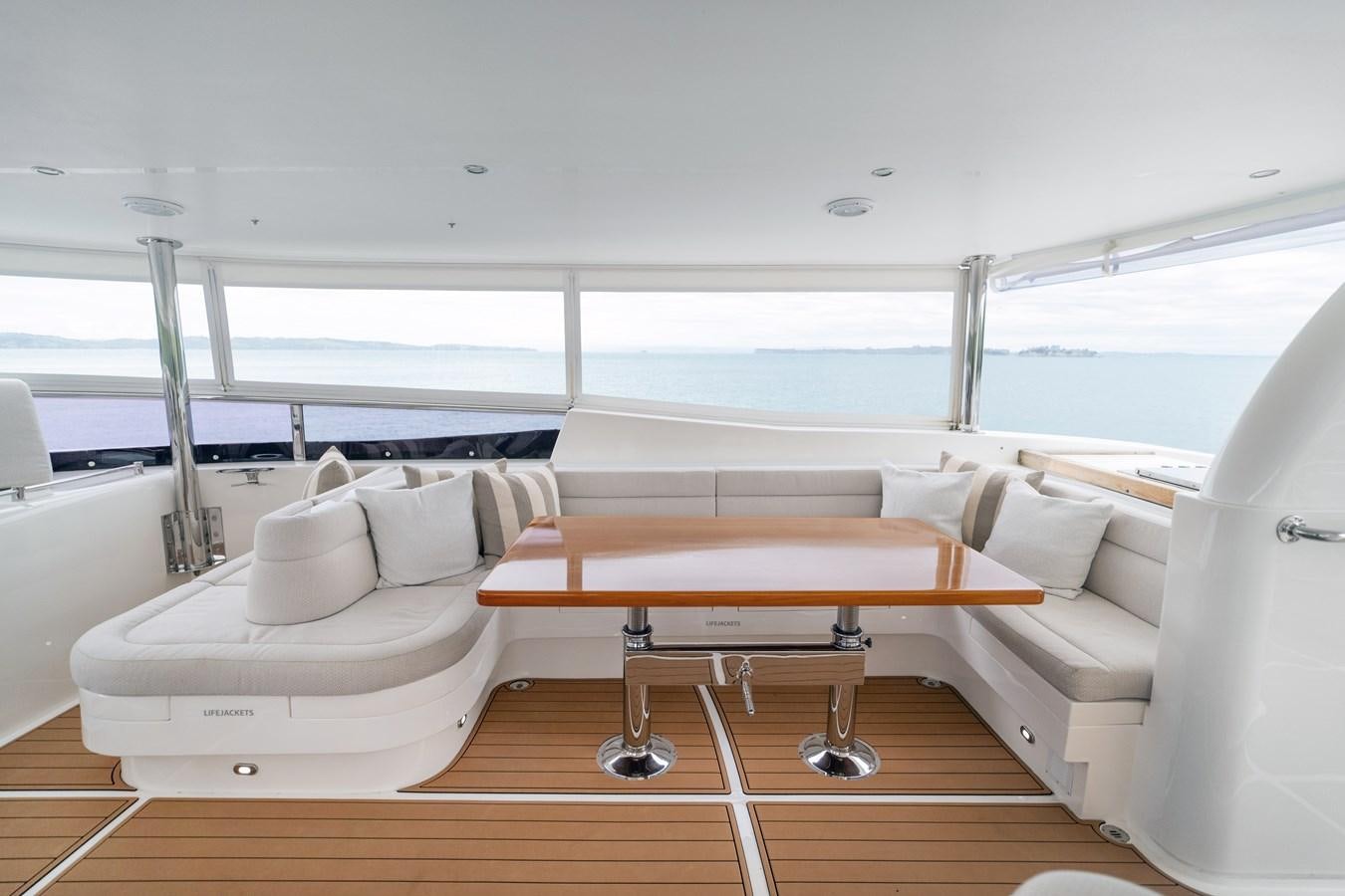 a room with a couch and a table aboard WW Yacht for Sale