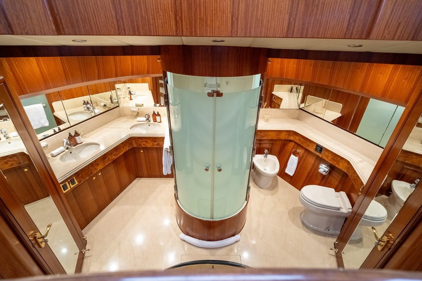 a bathroom with a green shower curtain aboard WW Yacht for Sale