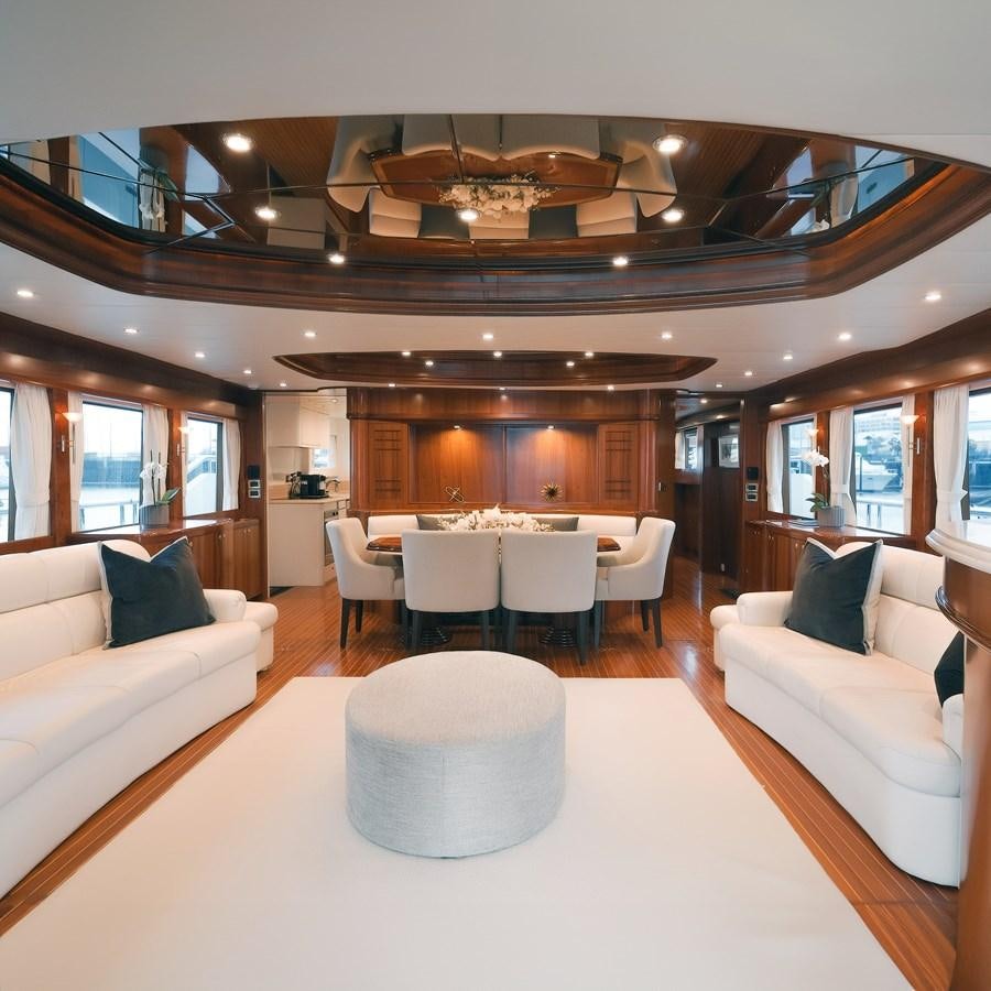a large living room with a large dining table aboard WW Yacht for Sale