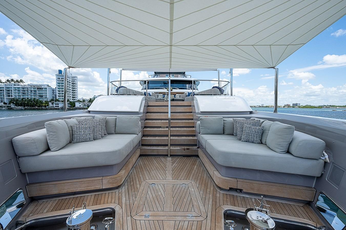 a deck with a couch and a large window overlooking a city aboard F 118 Yacht for Sale
