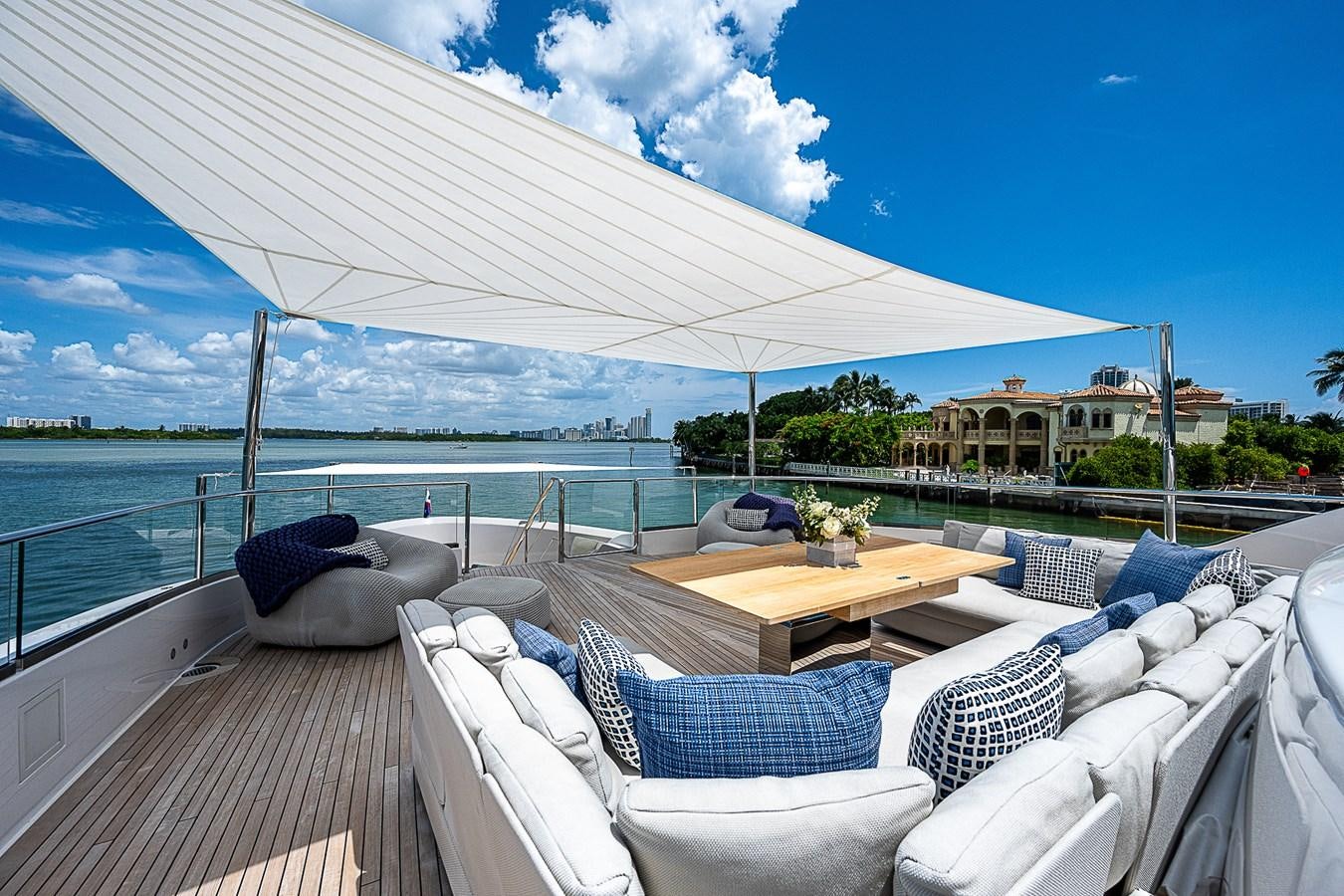 a deck with chairs and a table on it aboard F 118 Yacht for Sale
