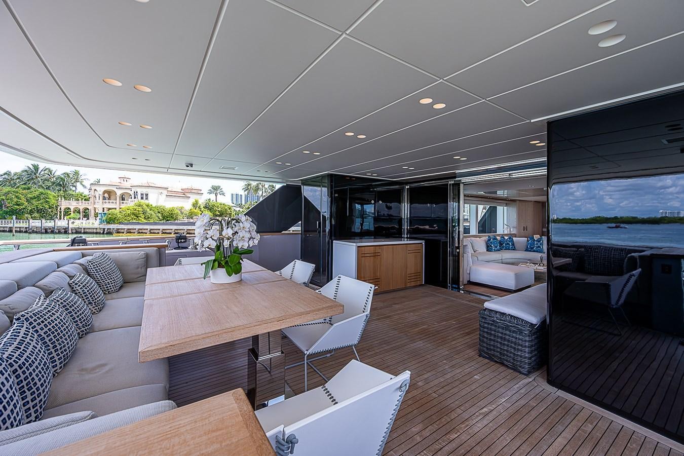 a room with a table chairs and a television aboard F 118 Yacht for Sale