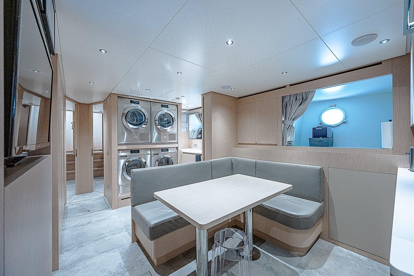 a room with a table and chairs aboard F 118 Yacht for Sale