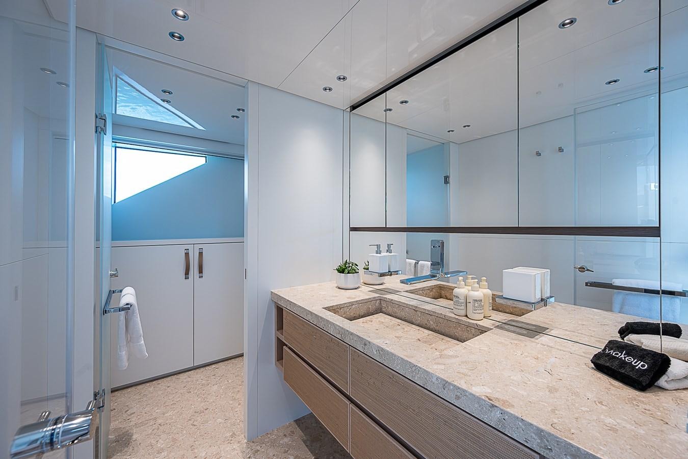 a bathroom with a countertop sink and a large mirror aboard F 118 Yacht for Sale