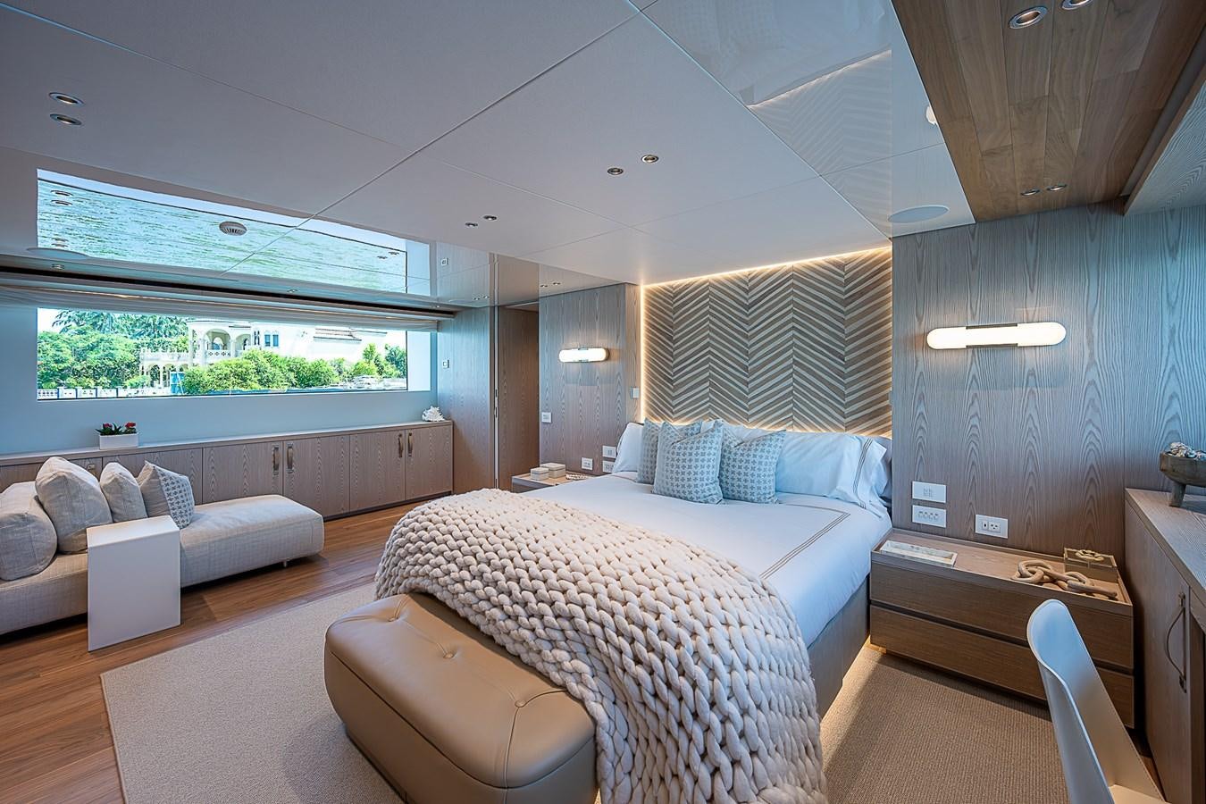 a bedroom with a bed and a couch aboard F 118 Yacht for Sale